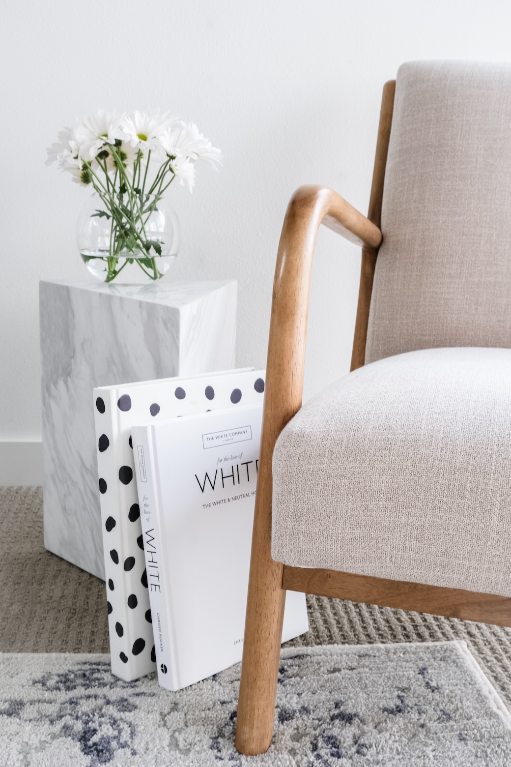 Clouse up of a modern chair with books and flowers